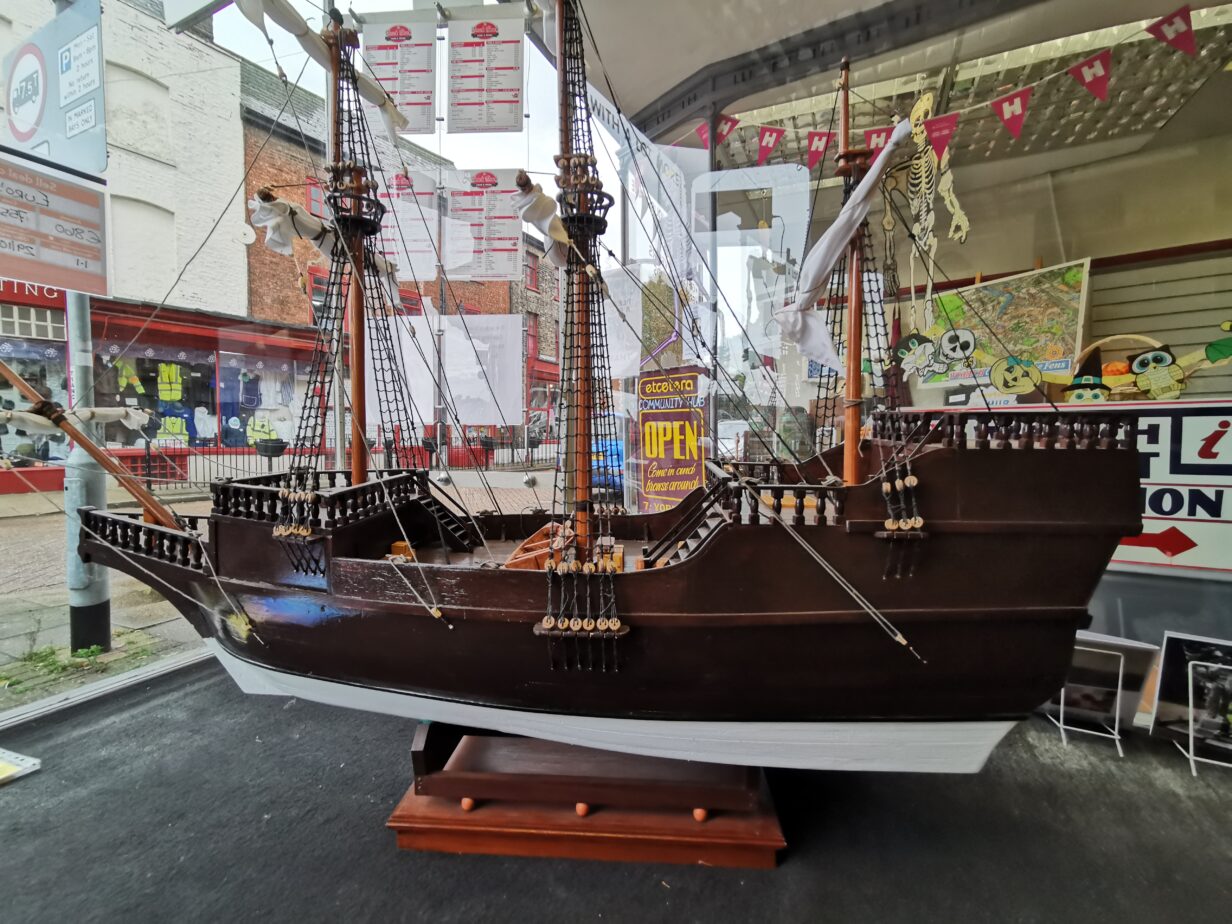 photo of a model of the Mayflower taken from the Window of Etcetera Hub, with a new out of the window to the street